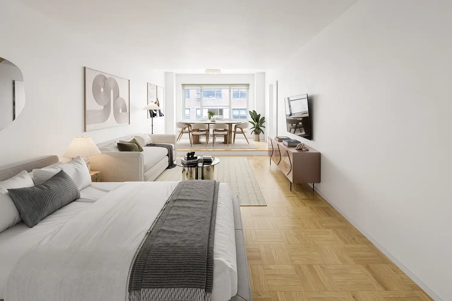 Modern living room and dining area from a real estate property listed by Adam Gerber, with white walls, light wood flooring, a bed, grey and white sofas, a wall-mounted TV, a glass coffee table, a dining table with chairs, and decorative wall art.