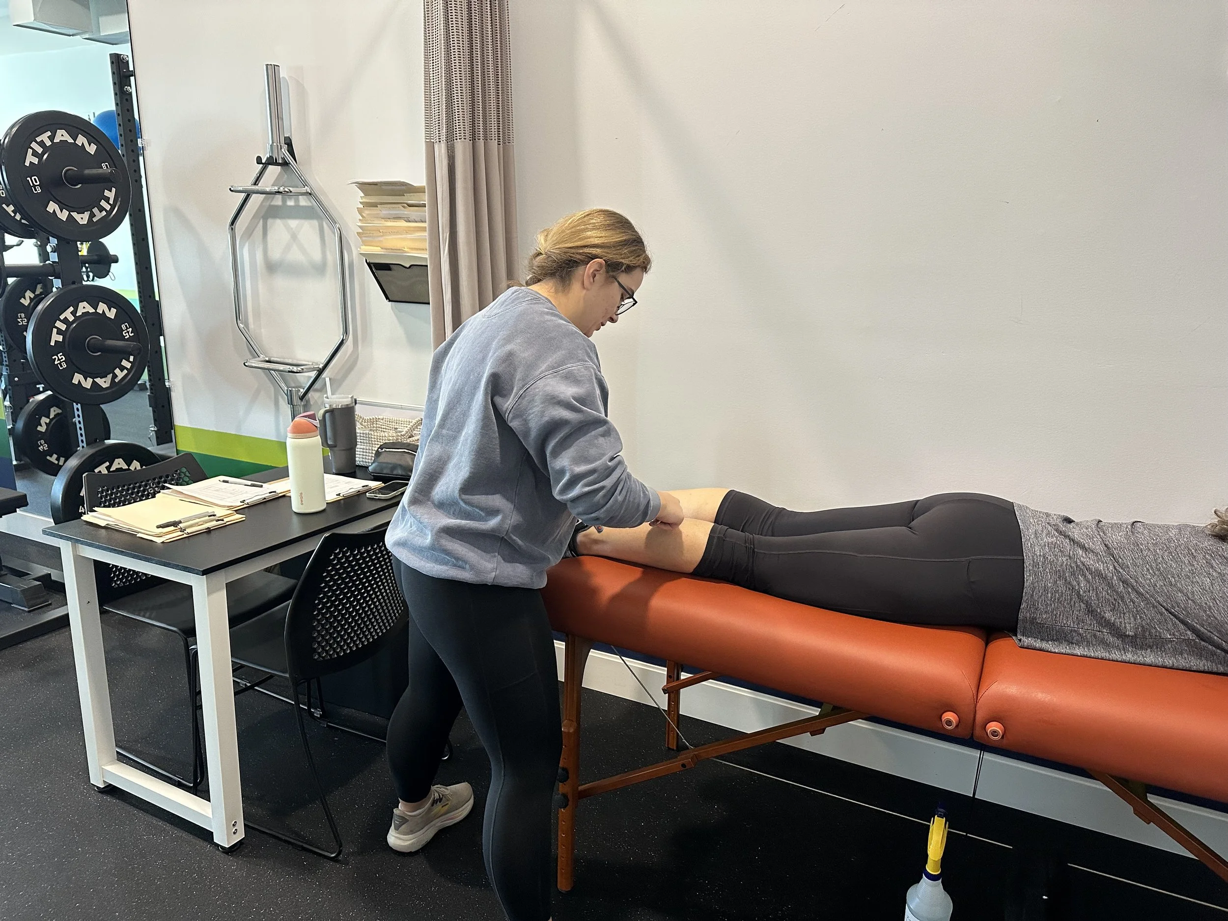 Kaela Frailing, physical therapist in portage michigan, does manual therapy on women's calf pain