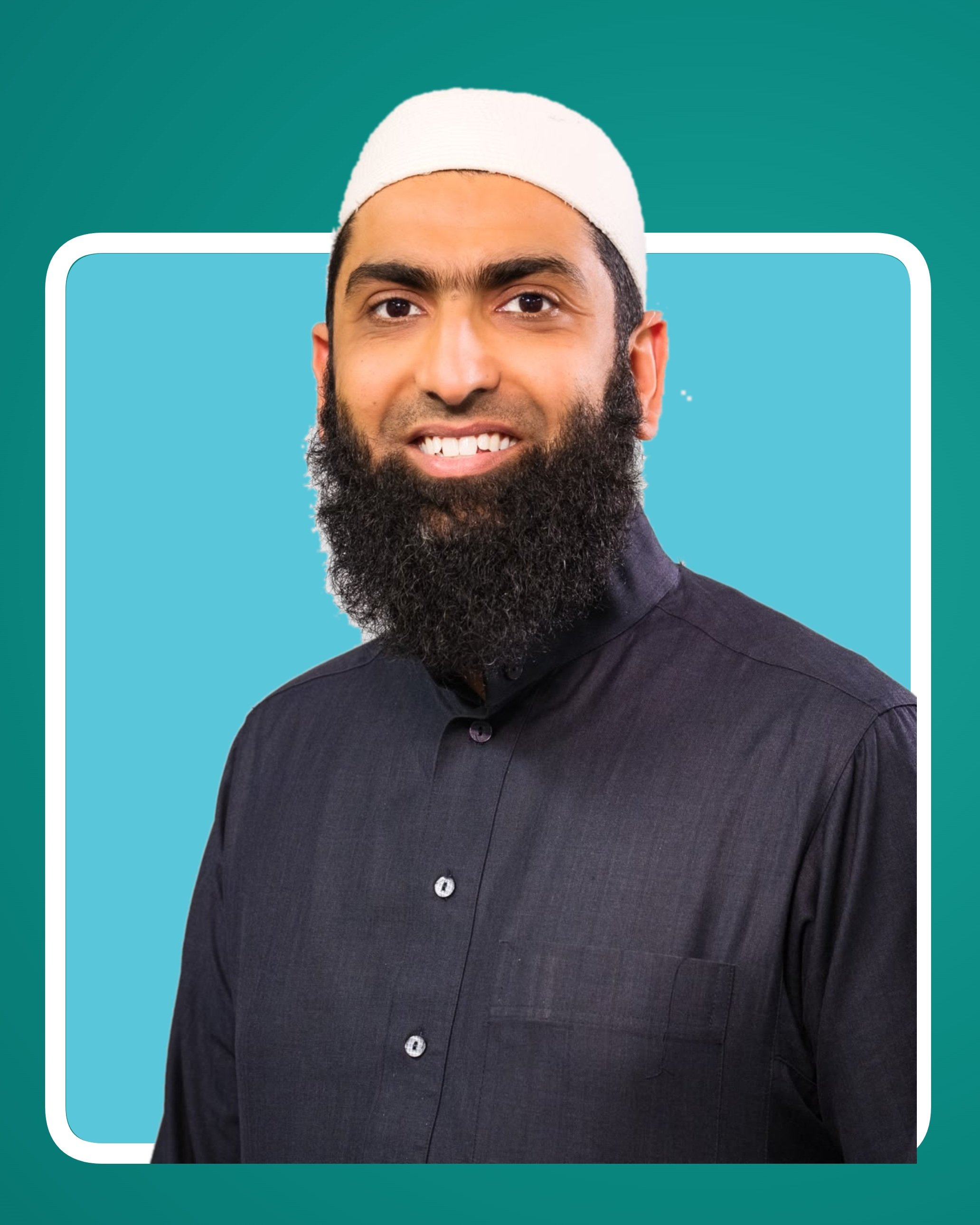 Shaykh Abdurrahman Anwar smiling, wearing a cream cap and a dark grey shirt.