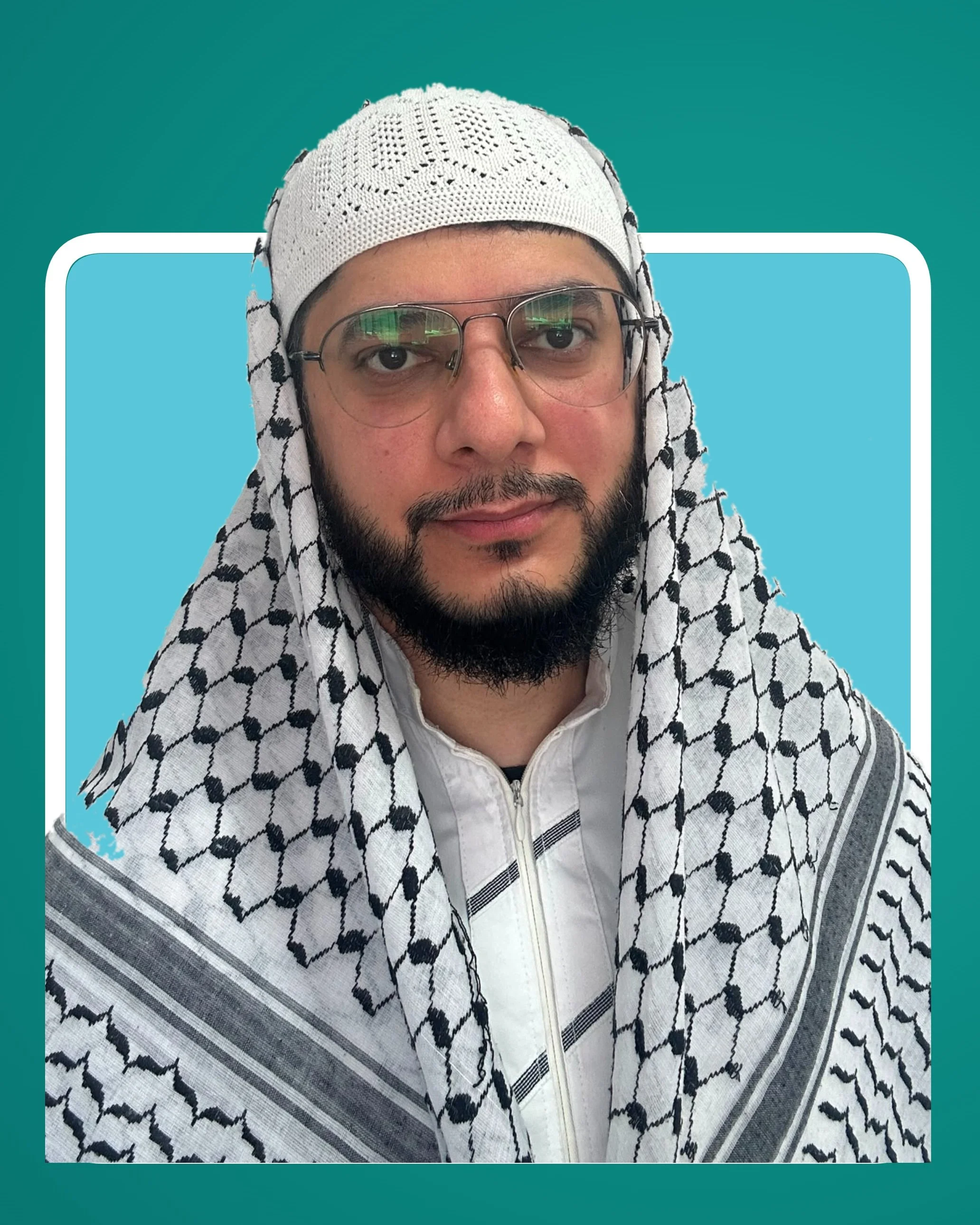 Ustadh Kamran Tariq wearing glasses, a white cap and a black-and-white patterned keffiyeh.