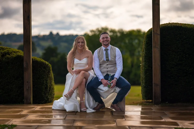 Bride and groom sitting together on a terrace