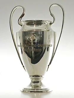 A silver trophy cup with two curved handles, representing a championship award.