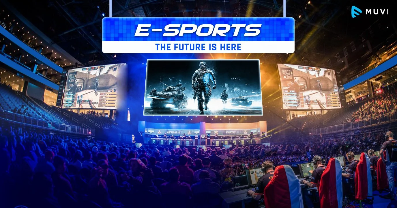 Large indoor e-sports event with a big stage, giant screens showing video game gameplay, crowded audience, and players at computers with headsets and red and white chairs.