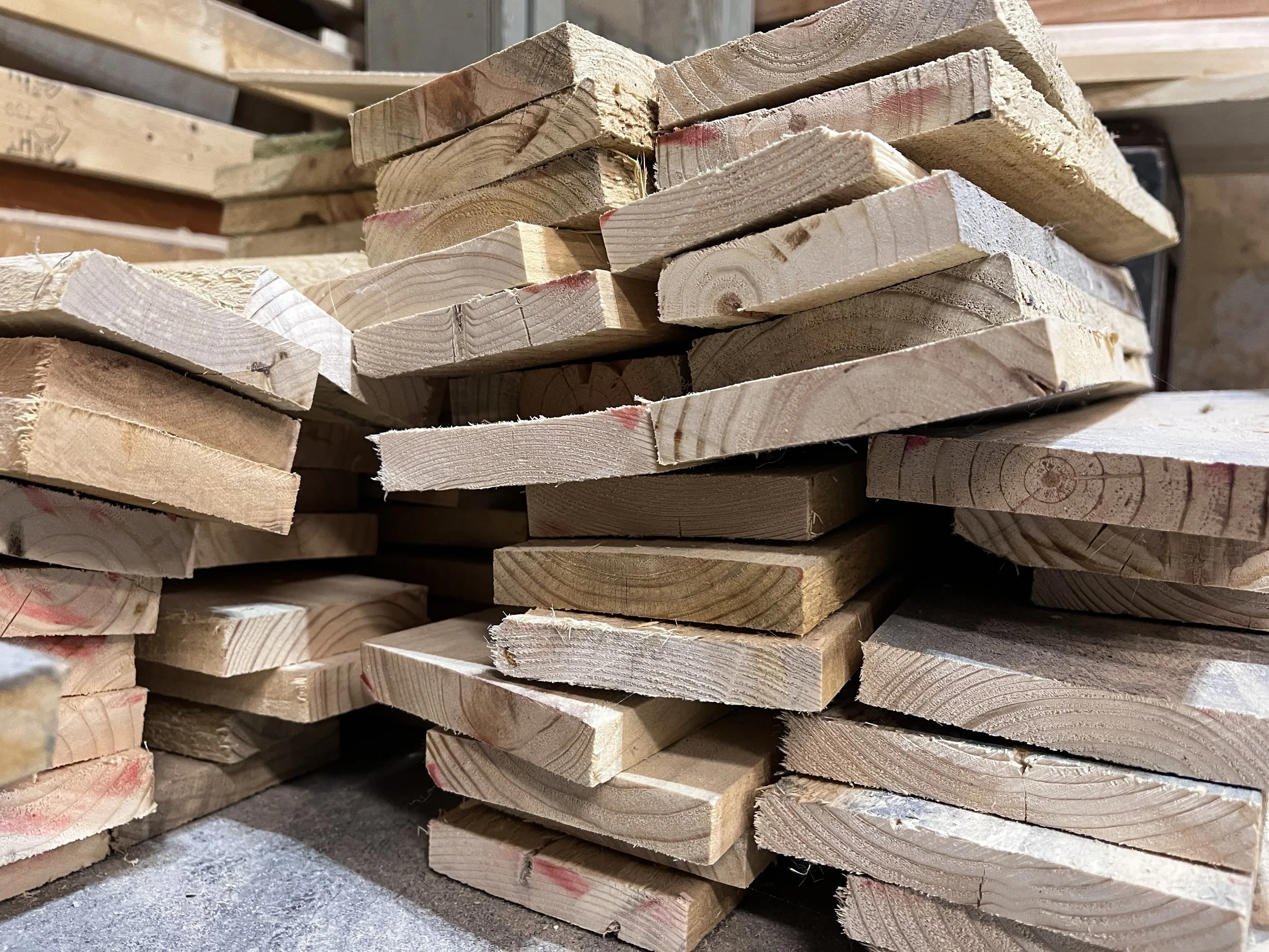 A stack of chopped wooden planks in a woodworking shop.
