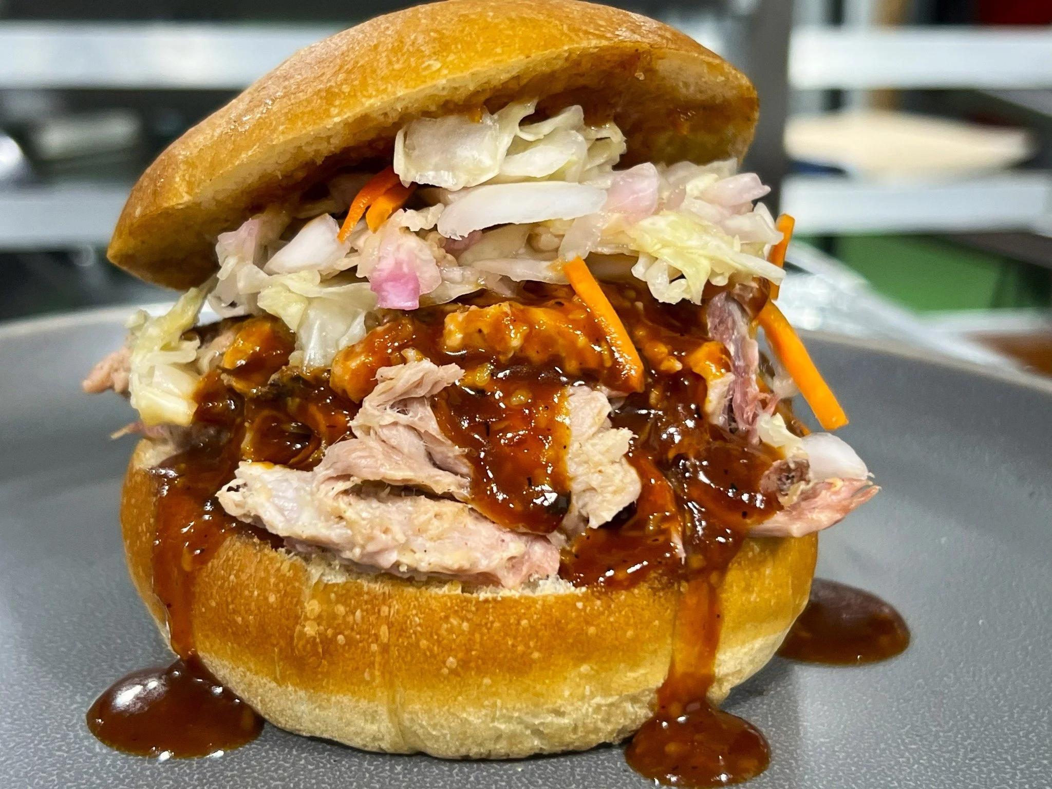 🔥 BBQ Done Right.

Our house-smoked pulled pork starts with premium Duroc pork shoulder, slow-smoked in-house until it&rsquo;s tender, juicy, and full of rich barbecue flavor.

We pile it high and finish it with our house-made BBQ sauces&mdash;sweet
