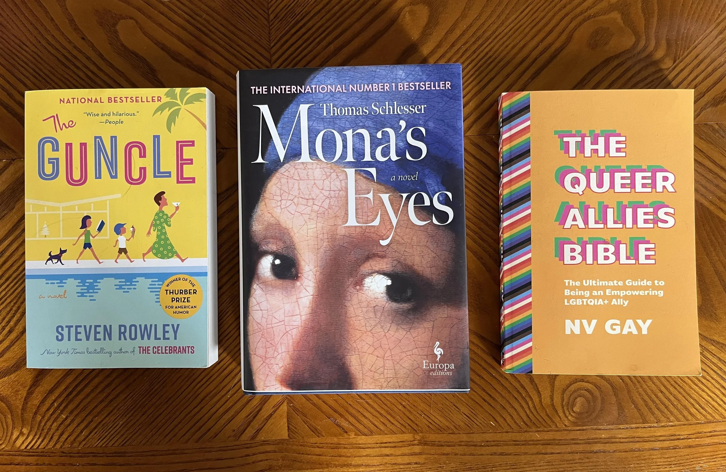 image of 3 books. from left to right, The Guncle, Mona's Eyes, and The Queer Allies Bible