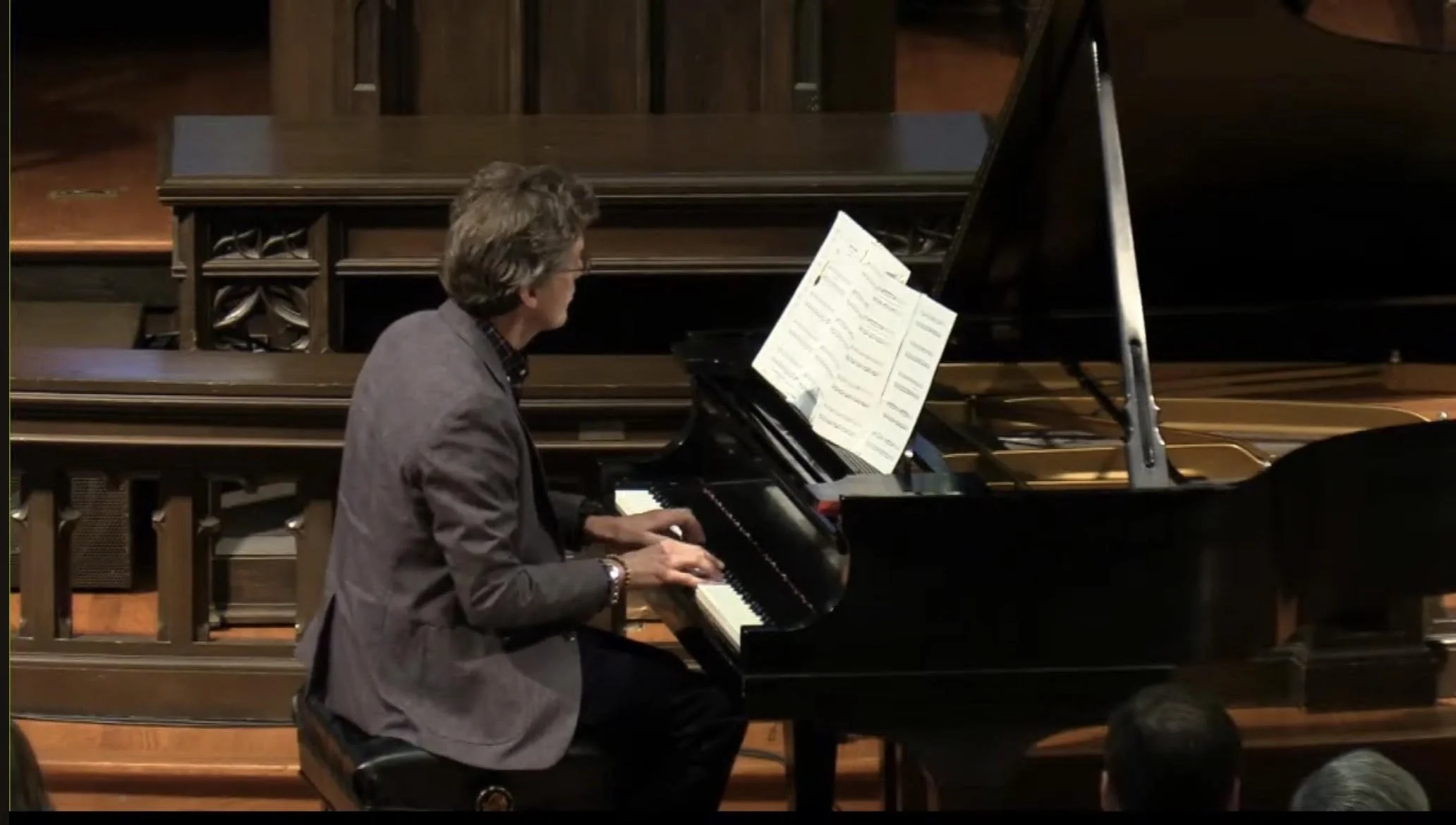 sideview of author andrew welsh huggins playing piano