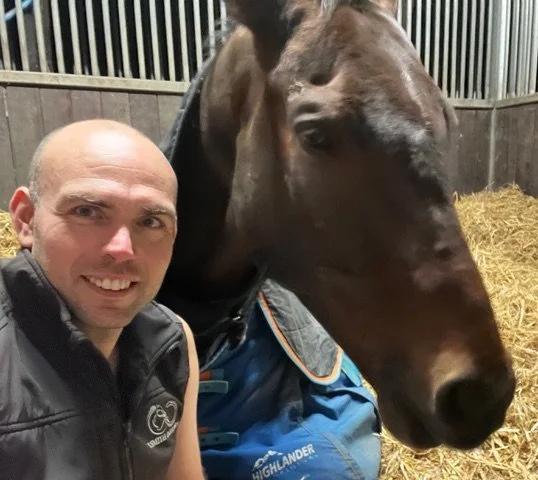 Headshot image of tom smith with a bay horse