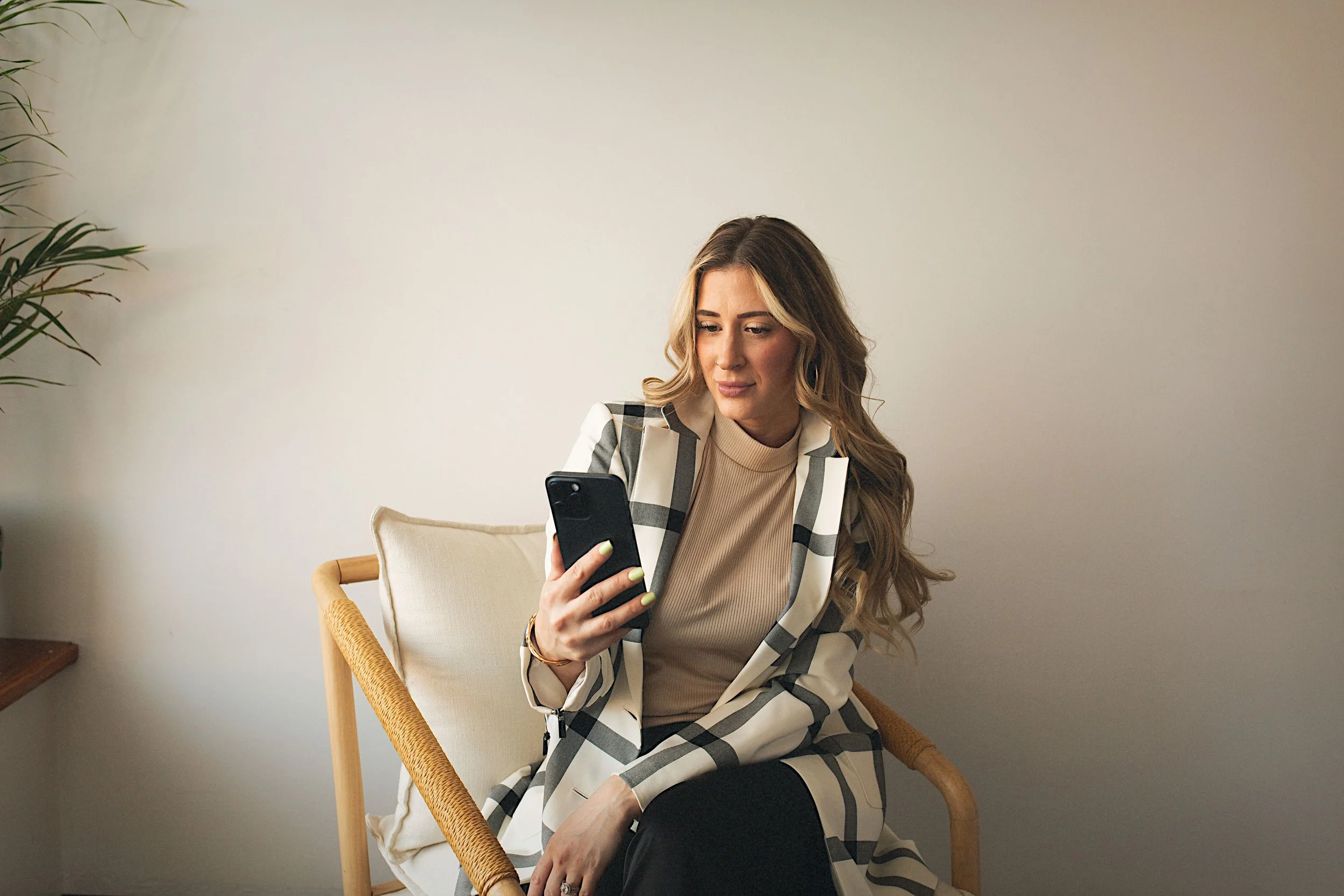 Anna Hoff of Anna & Co. Marketing creating content and managing client social media accounts in a clean, modern studio environment.