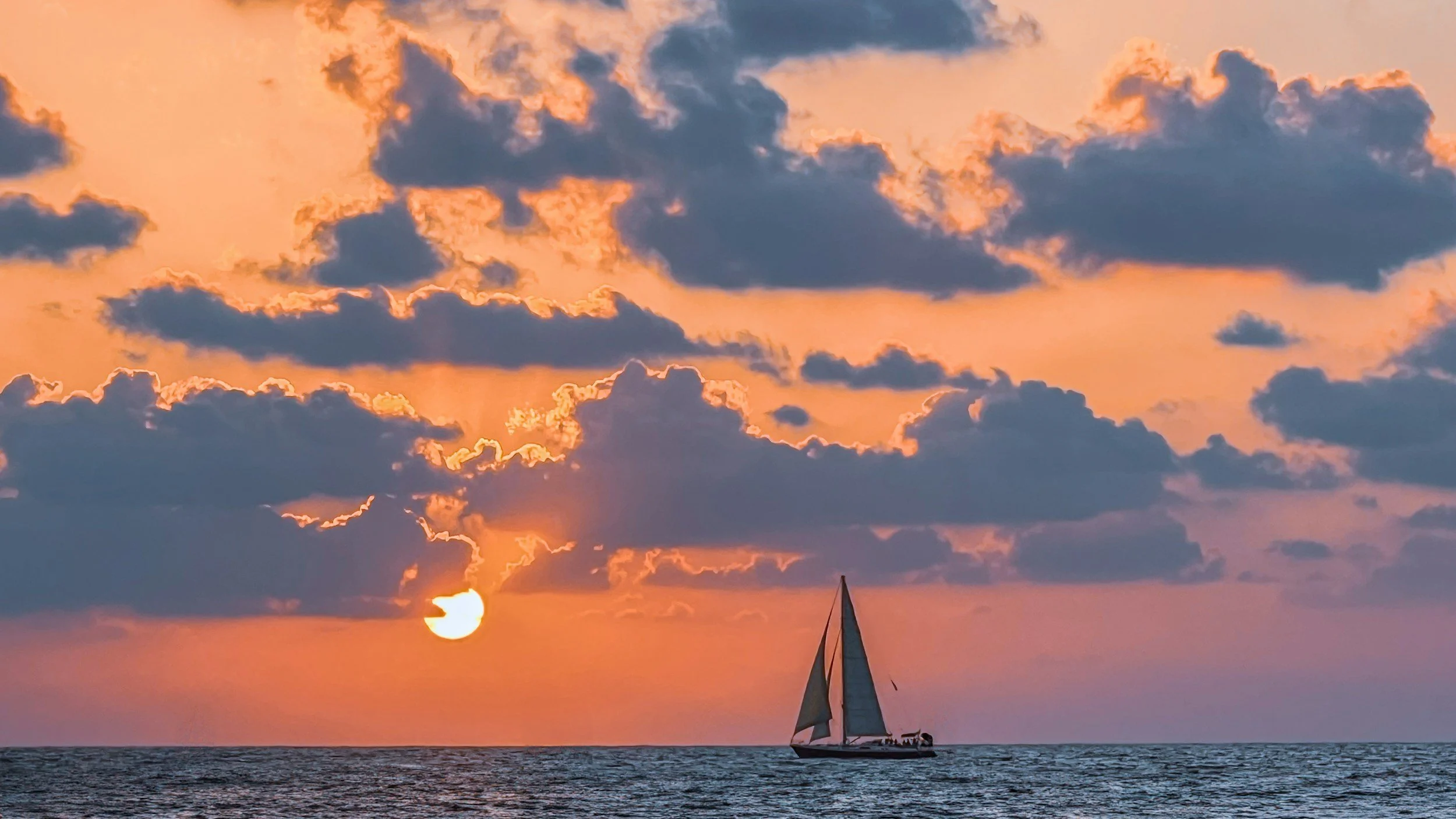 sail boat at sea with California sunset