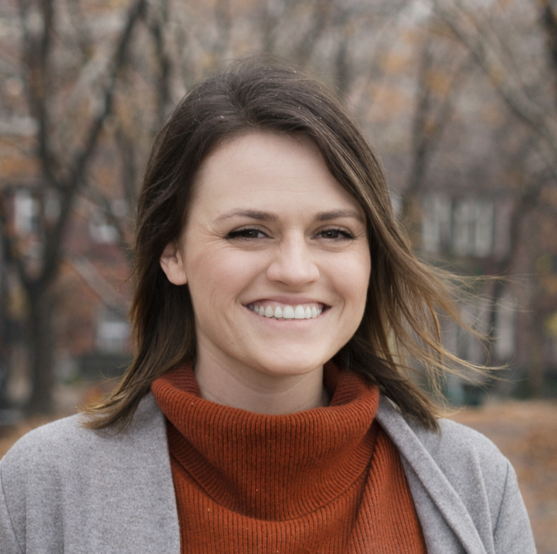 Allie, content and SEO specialist, smiling outdoors with trees and houses in the background.