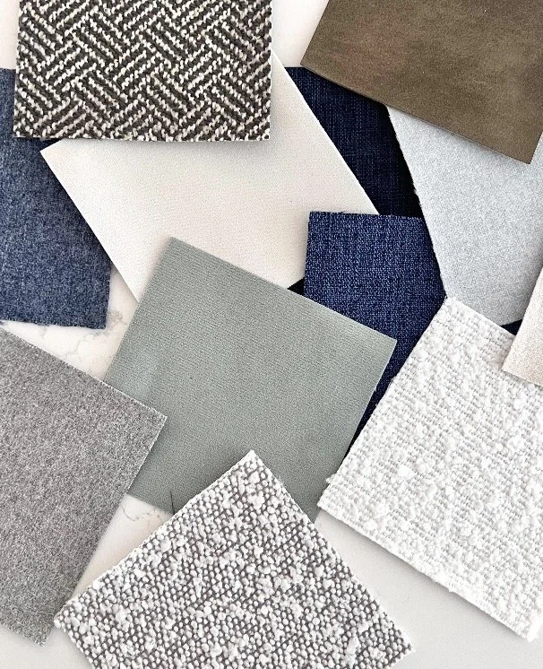 Sample swatches of various fabric or material textures and colors, including neutral tones, blues, gray, white, and patterns.