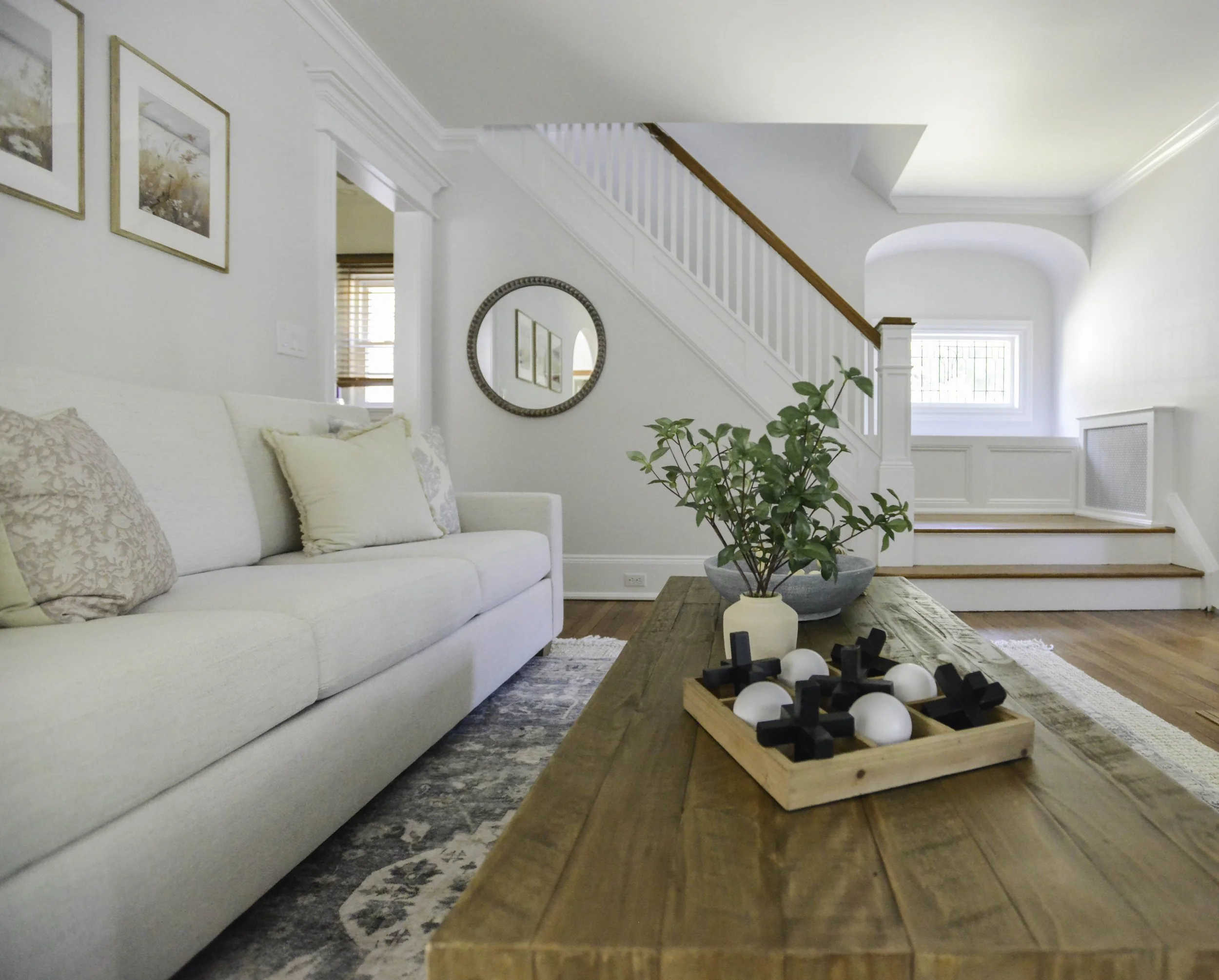 Wood rustic coffee table, pottery barn performance sofa, ivory sofa, blue area rug, coastal farmhouse design, light and bright living room