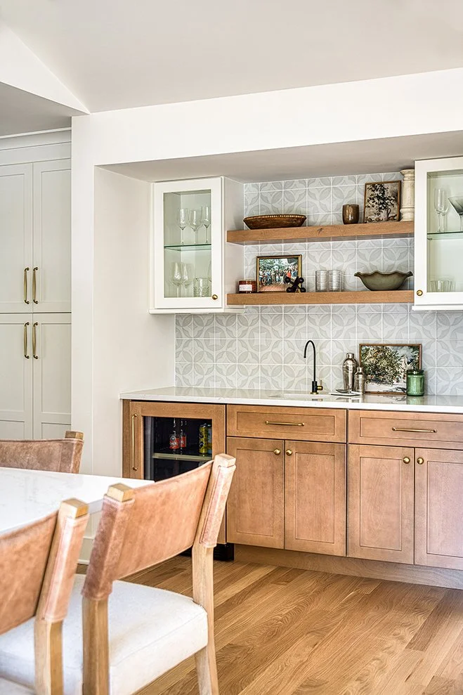Kitchen with wooden cabinets, open shelves, a small wine cooler, and a patterned tile backsplash.