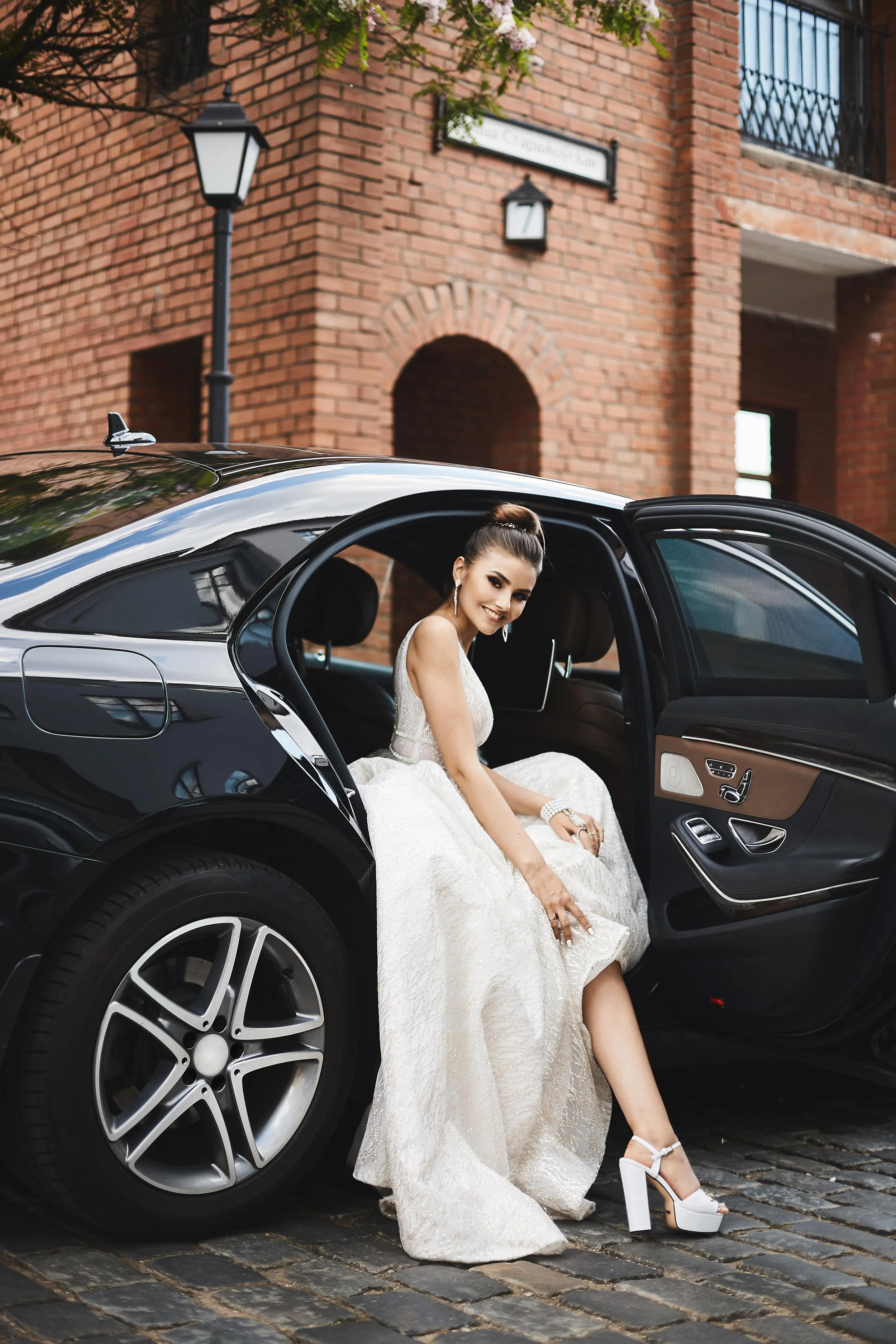 long-legged-brunette-model-girl-with-bright-makeup-trendy-silver-dress-sits-luxury-car-mi.jpg