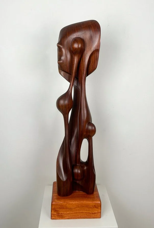 Fermin Castro  Caribbean Soul, abstract wood sculpture, smooth curves, openings, circles and balls, tall and slender on square base