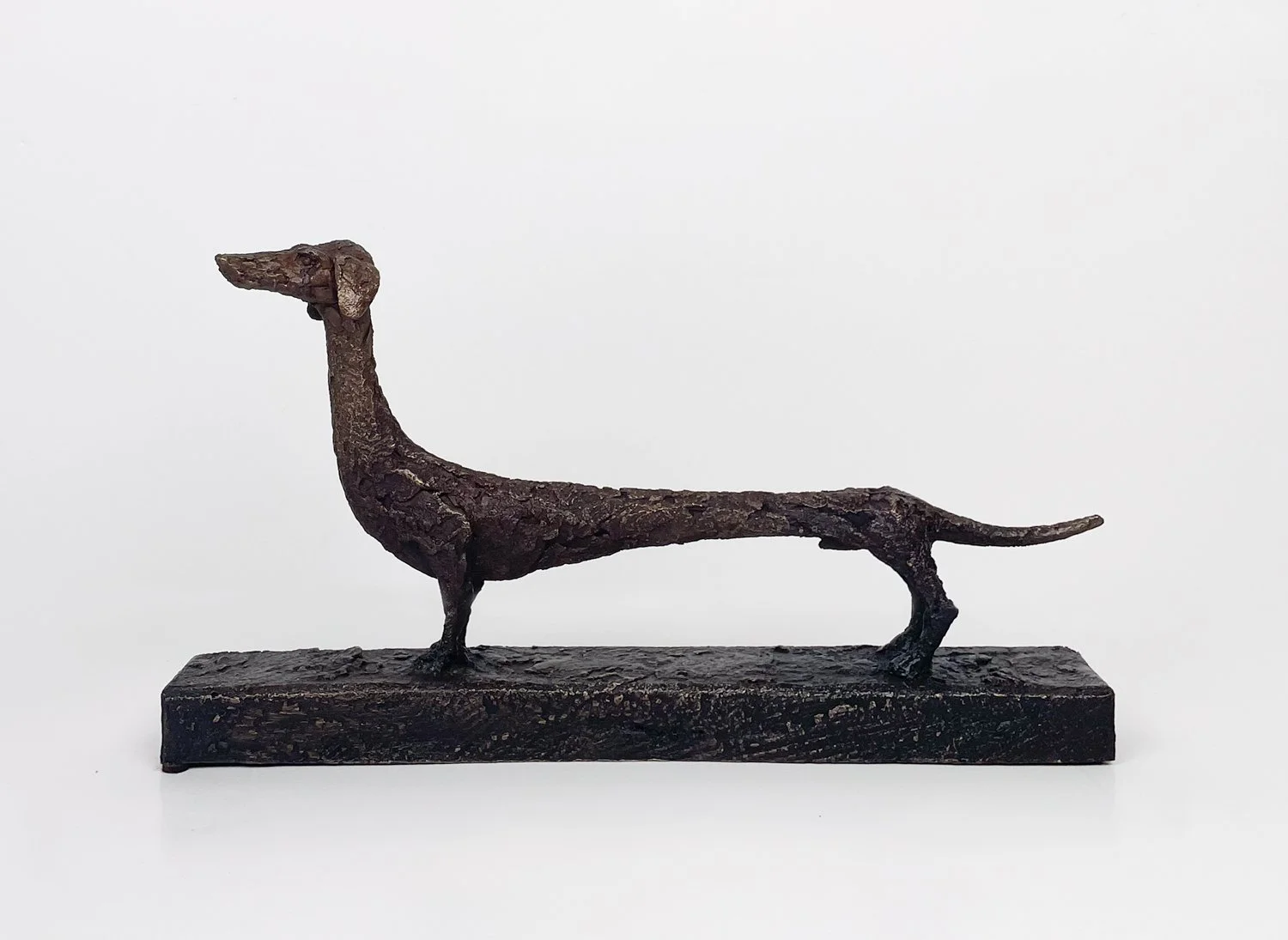 Gustavo Torres, Dachshund Dog, small dog in alert pose, warm brown patina on bronze, rough textured surface
