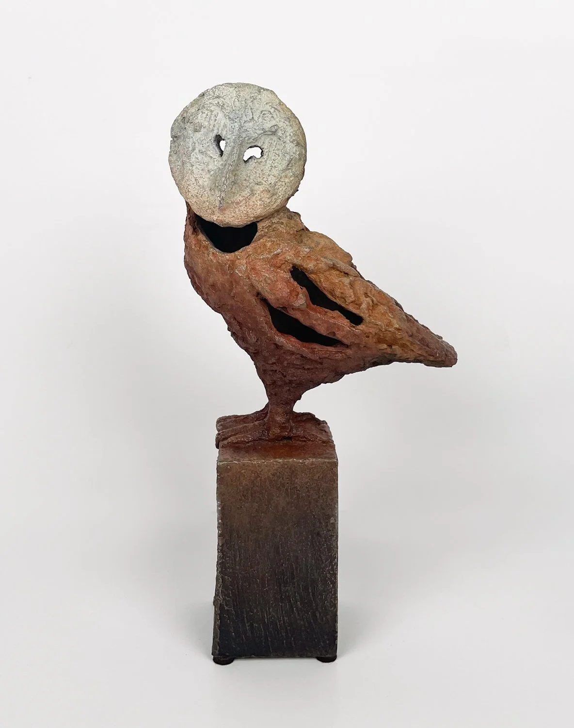 Gustavo Torres, Buho (Small), abstracted owl with holes through hollow body, rough, textured surface, light cream patina on head fading to warm rid red patina on body