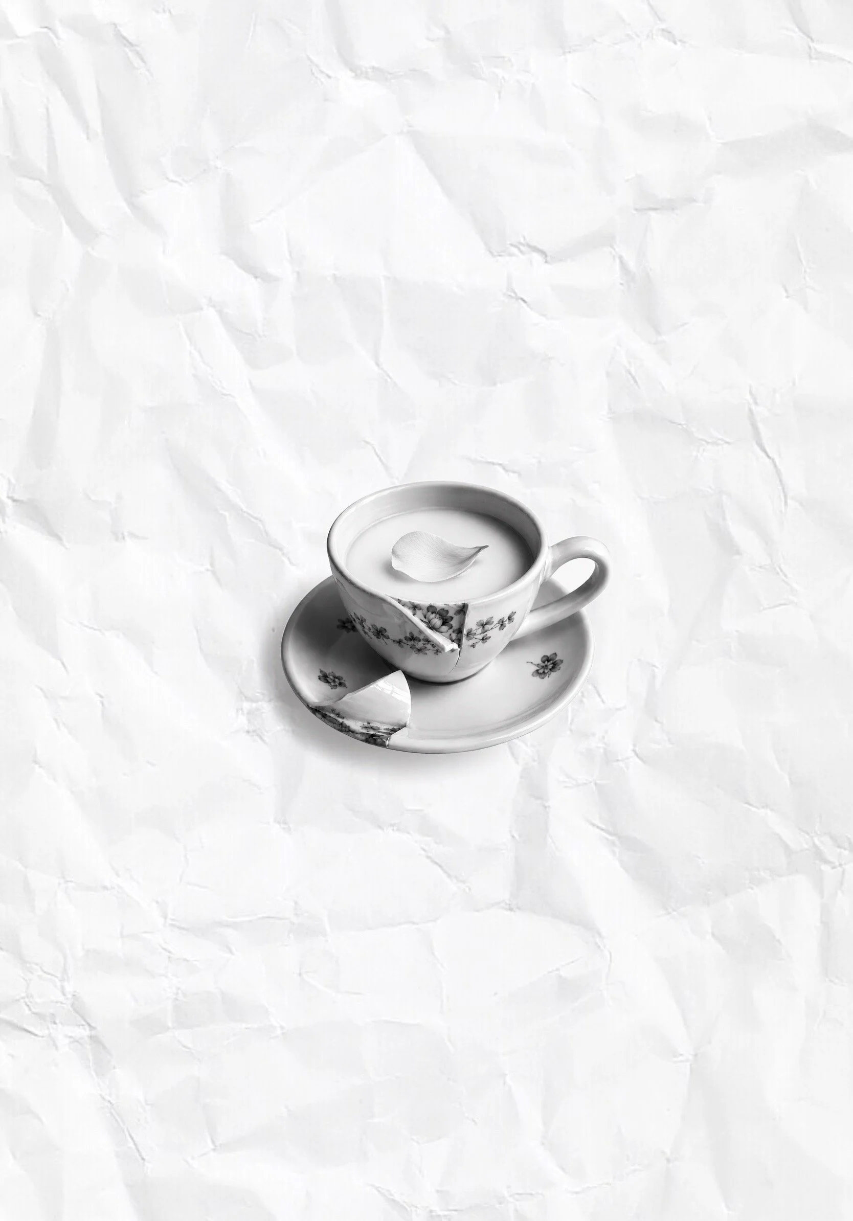 Micro realism tattoo project depicting a white teacup filled with milk or cream, placed on a matching saucer with floral patterns.