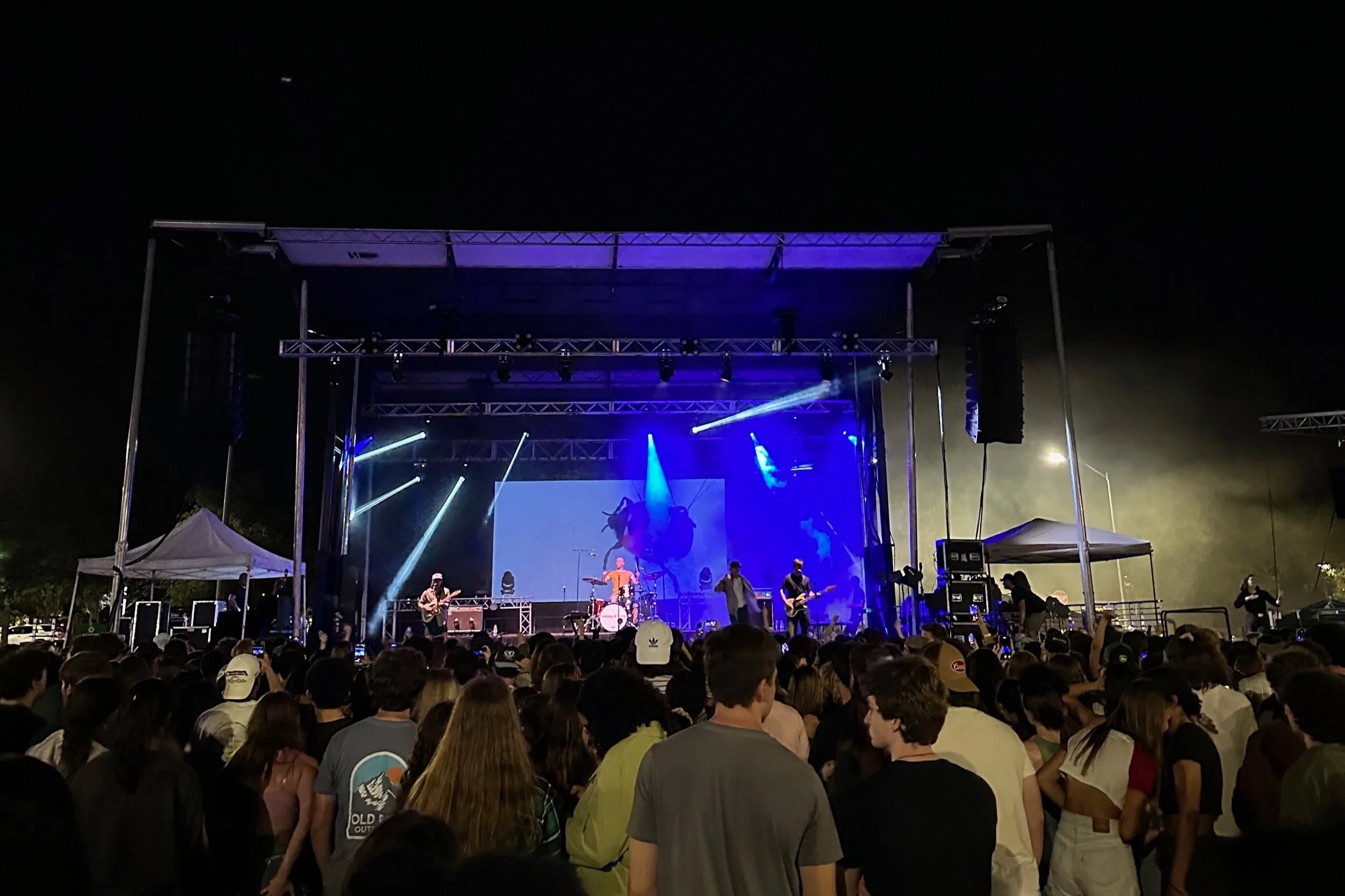 Photo of musicians in a band on a stage.
