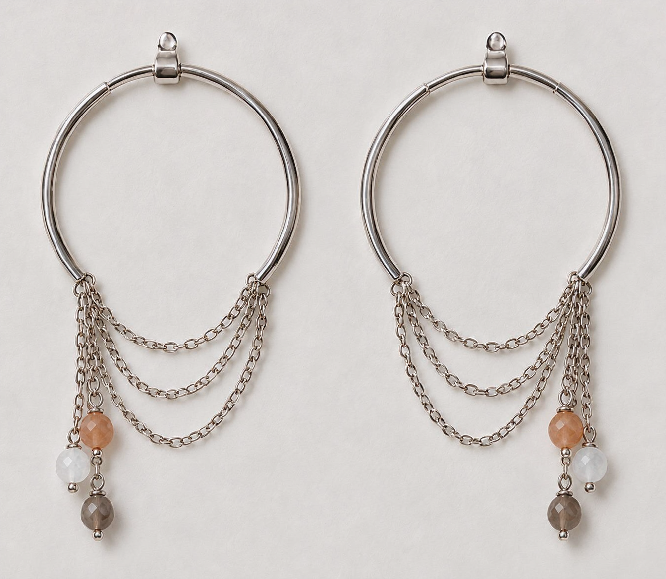 Zorya sterling silver hoop earrings with cascading chains and gemstone drops worn on ear