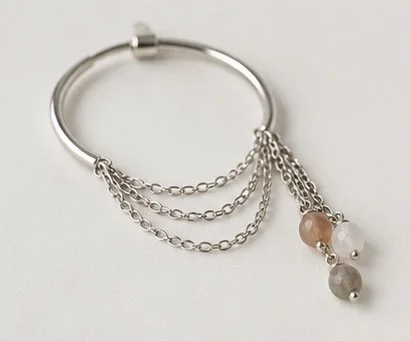 Zorya sterling silver hoop earrings with cascading chains and gemstone drops worn on ear