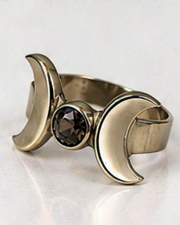 Silver triple moon ring with dark gemstone, angled view.png