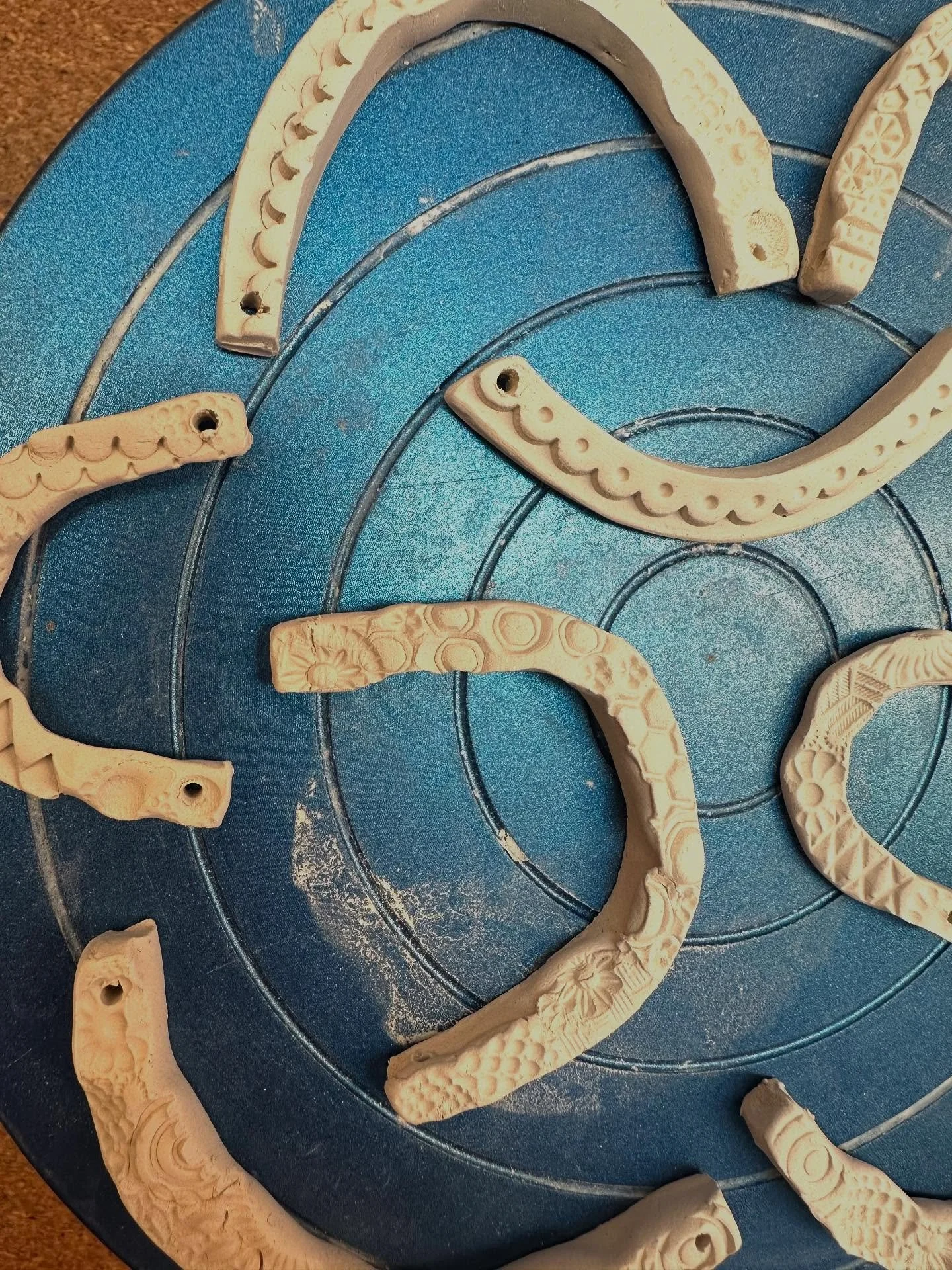 Working on crooked smile shapes. Here they are unfired. They are happy with their imperfections. . 💙. .  #ceramicjewelry #ceramics #artjewelry #smilefordays #handmade #oaktown #bayareaartist #oneofakindjewelry