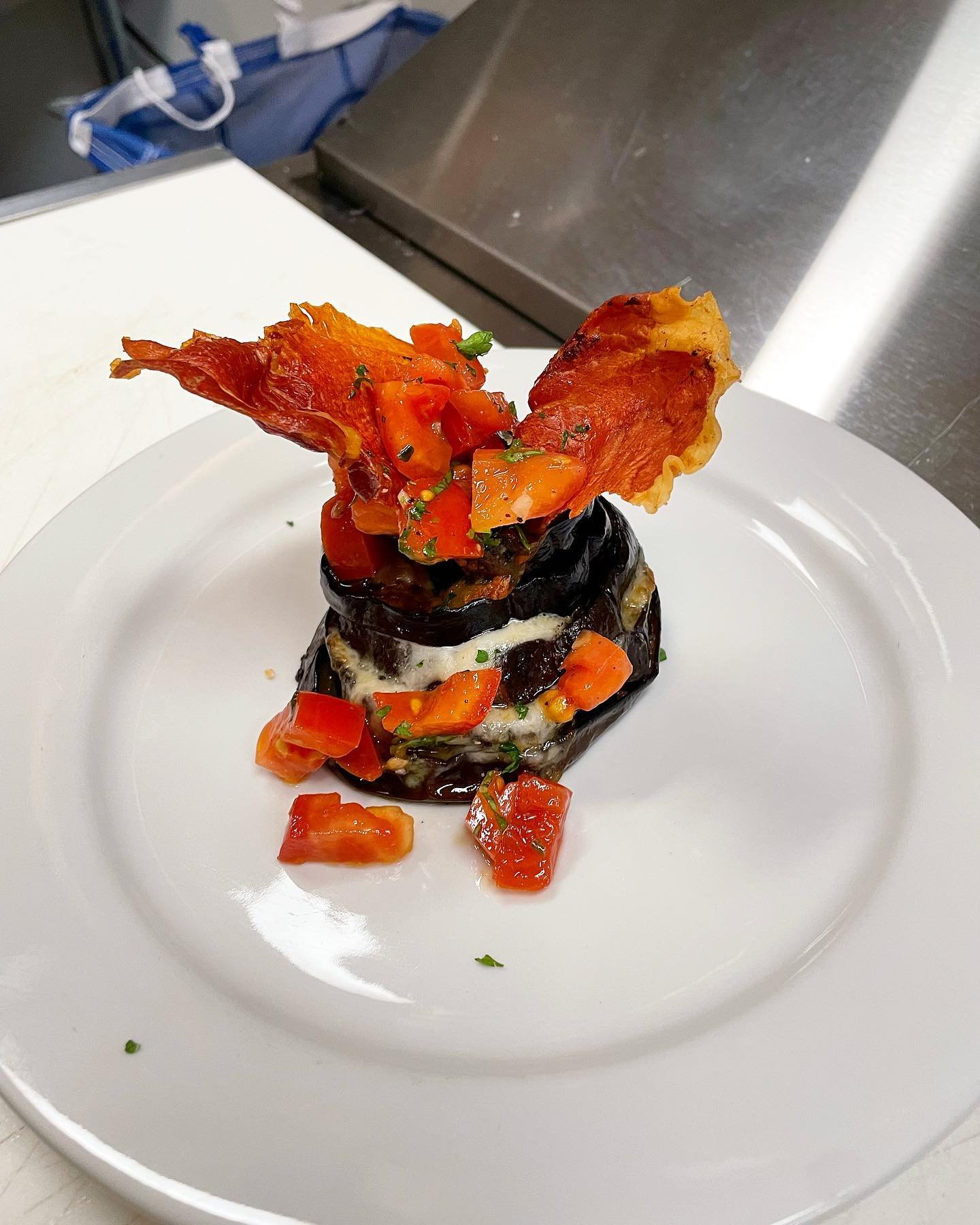 Eggplant tower with napoletana tomatoes and prosciutto crisp