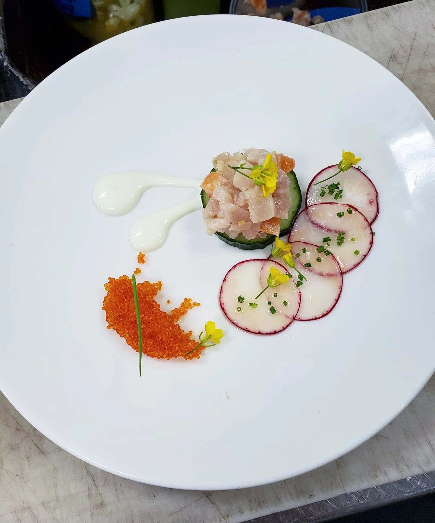 Citrus cured Hamachi w/ cucumber, wasabi creme, pickled radish, and tatsoi flower