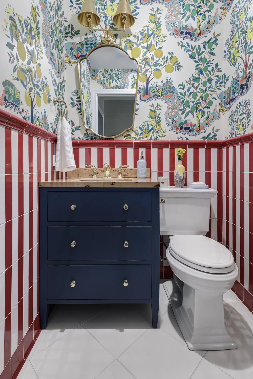 Powder room with red striped tile and botanical wallpaper in Chappaqua, New York