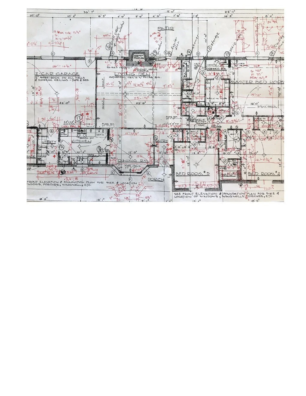 Detailed architectural floor plan of a house, showing rooms, measurements, and construction notes in red and black ink.