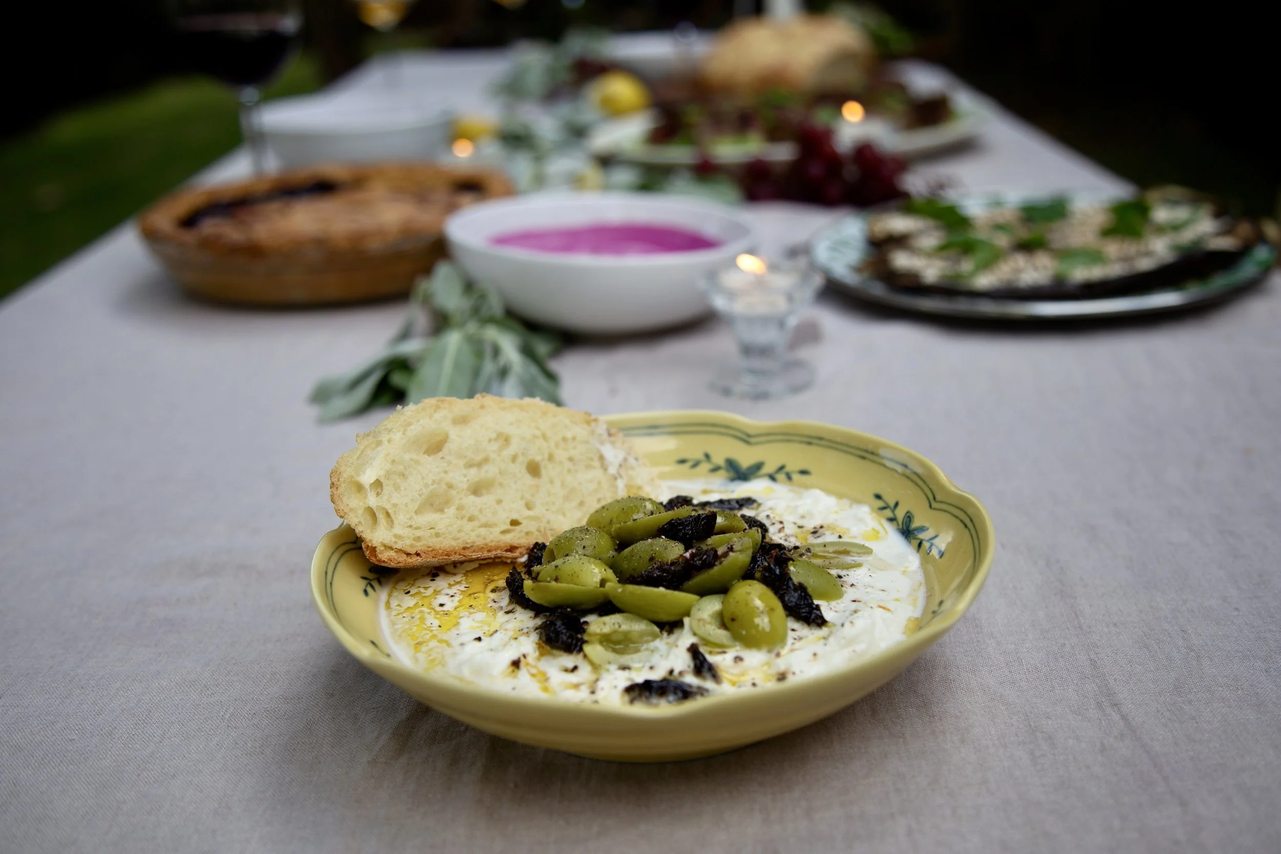 Marinated olives over creamy stracciatella with crusty bread
