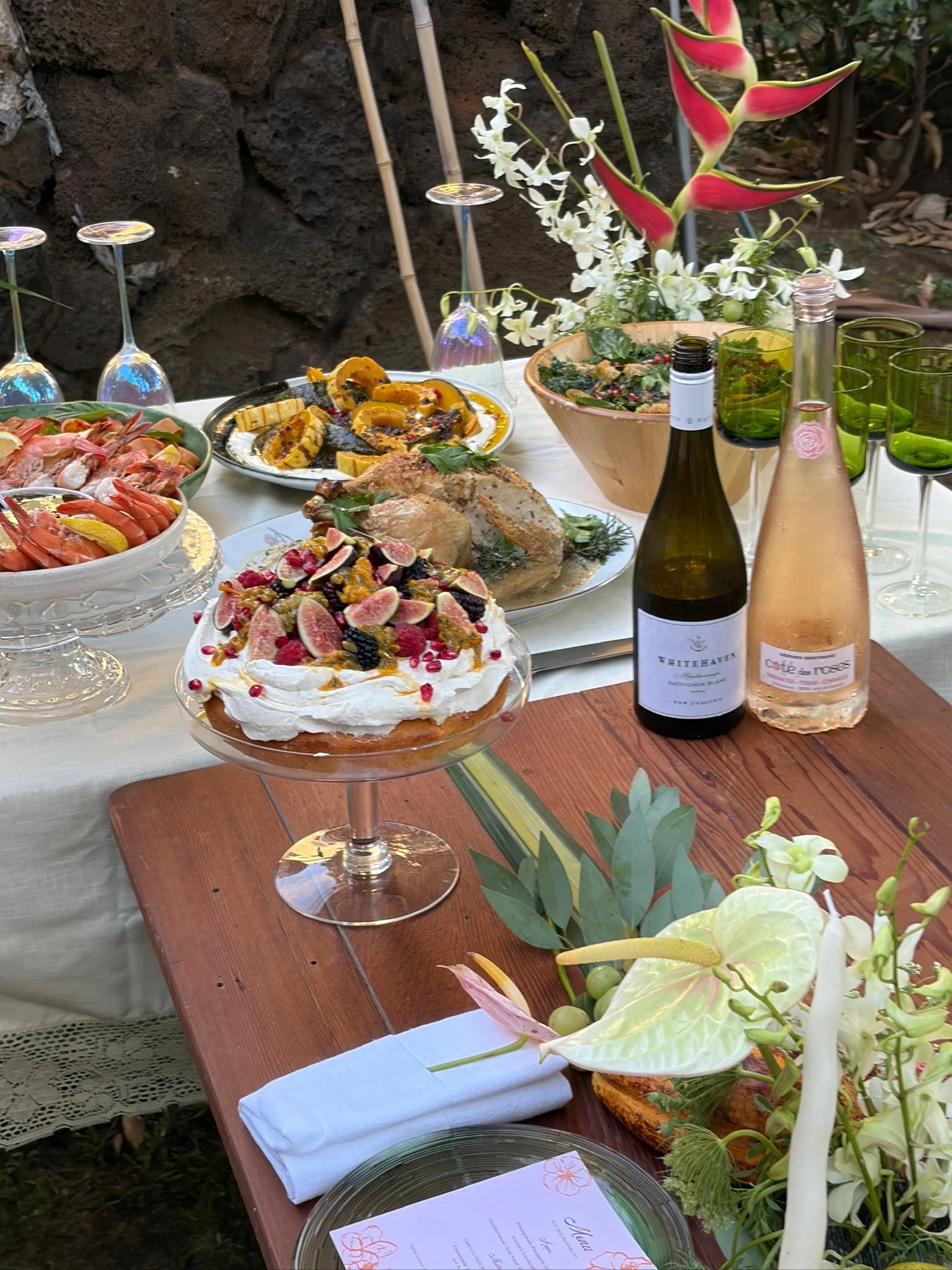 Italian lemon cake with whipped ricotta cream and figs on a dinner party table with seafood and wine