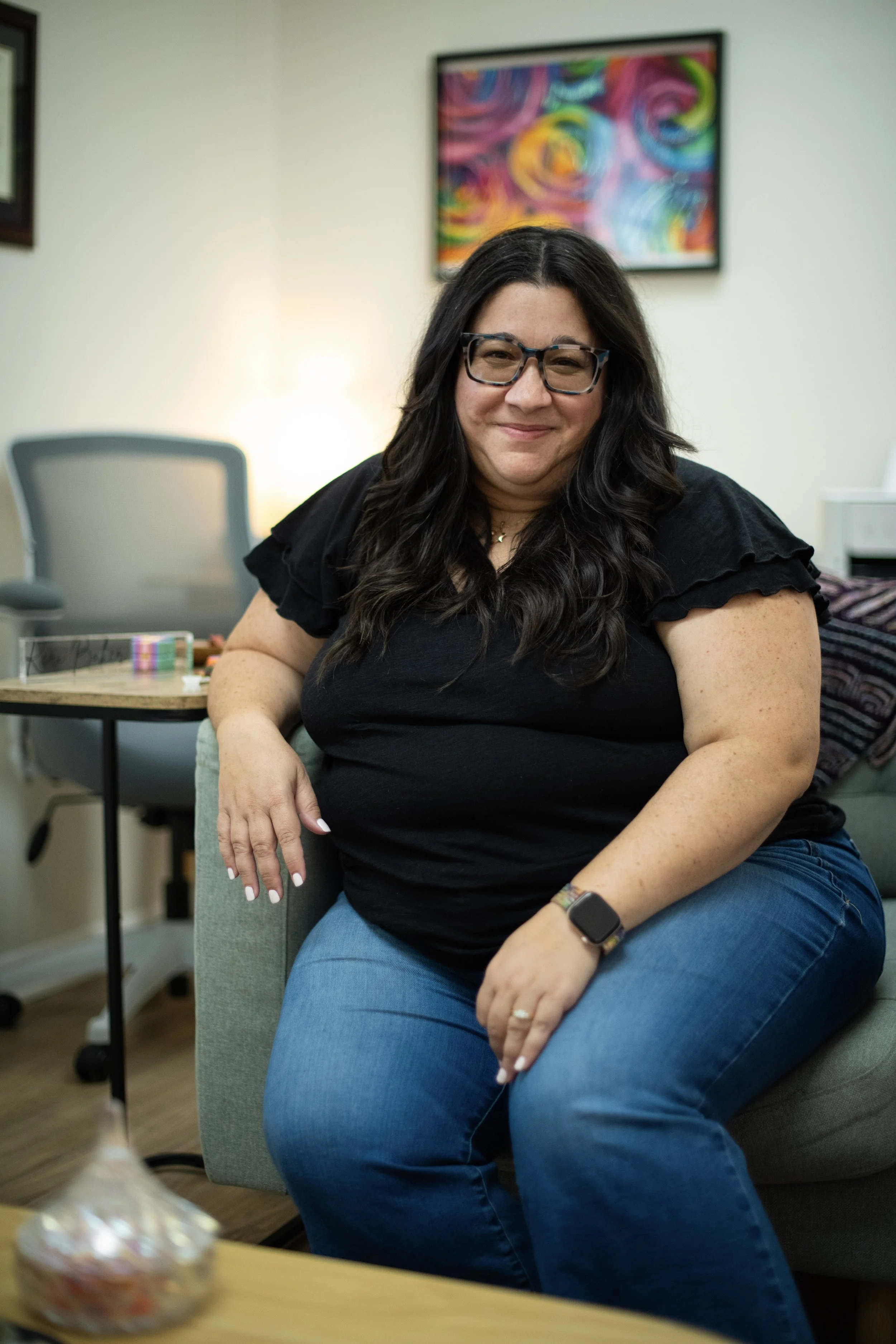 Keri Baker, LCSW, supervisor for clinical social work interns in Tampa, FL sitting in her office, smiling