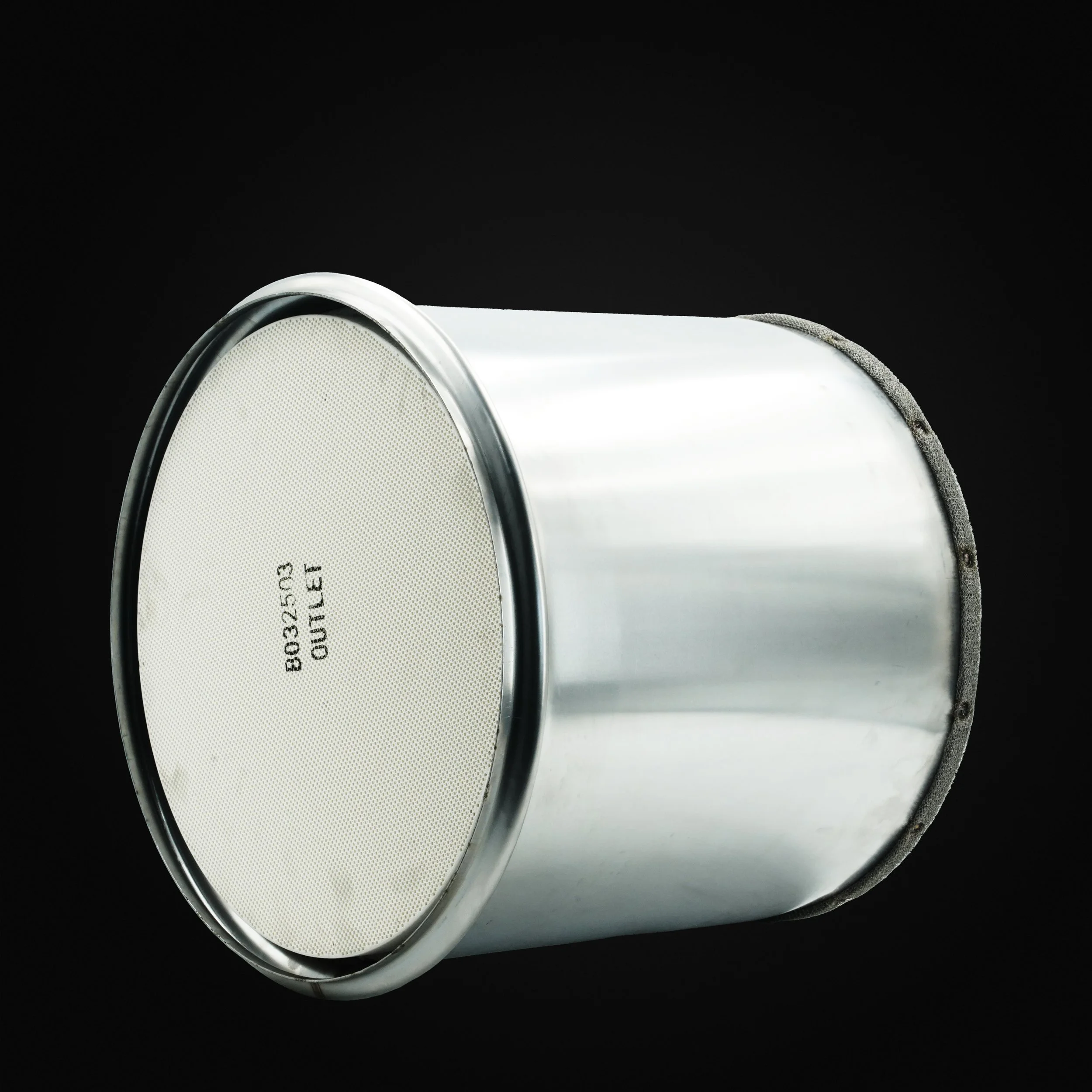 Silver metal canister with a white lid and black background.