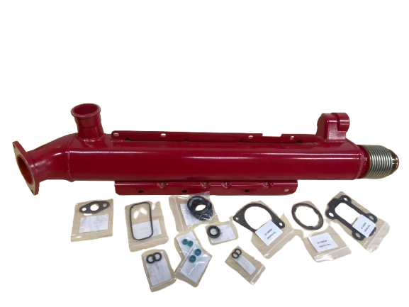 A large, red cylindrical device with various small parts and gaskets laid out in front of it.