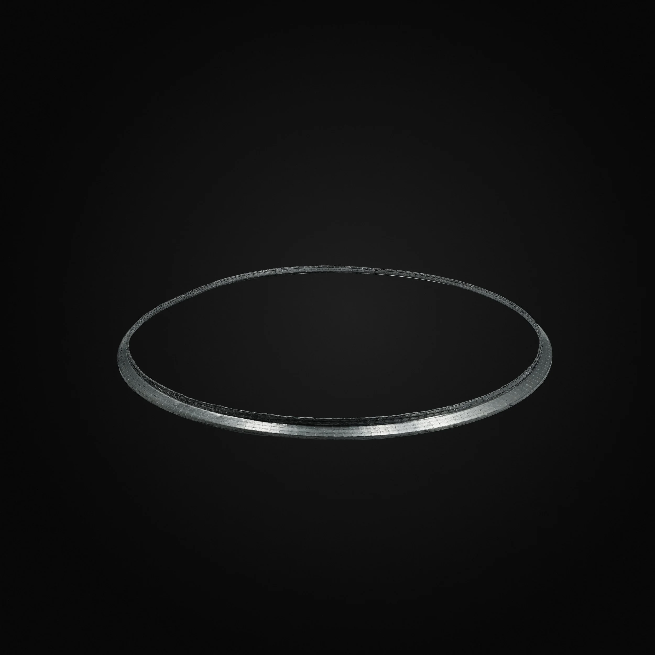 A silver ring or circular band on a black background.