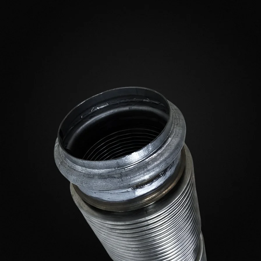 Close-up of a metallic shock absorber or hydraulic cylinder against a black background.