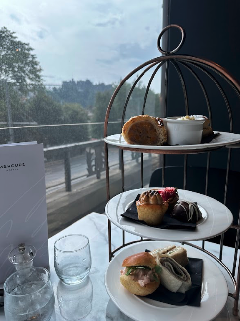 A tea caddy with three layers of British tea foods.