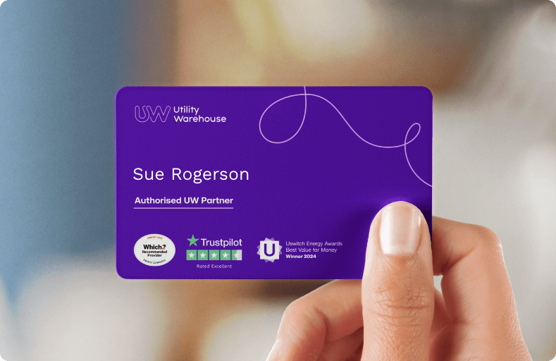 A person's hand holding a purple utility worker card with the name Sue Rogerson, Trustpilot rating, and awards logos on it.