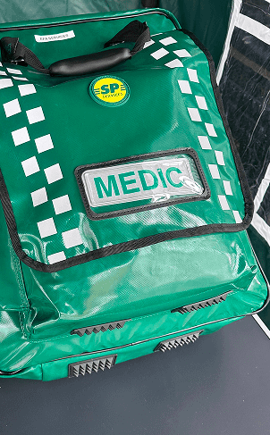 Green emergency medical response bag with MEDIC label and checkered pattern.