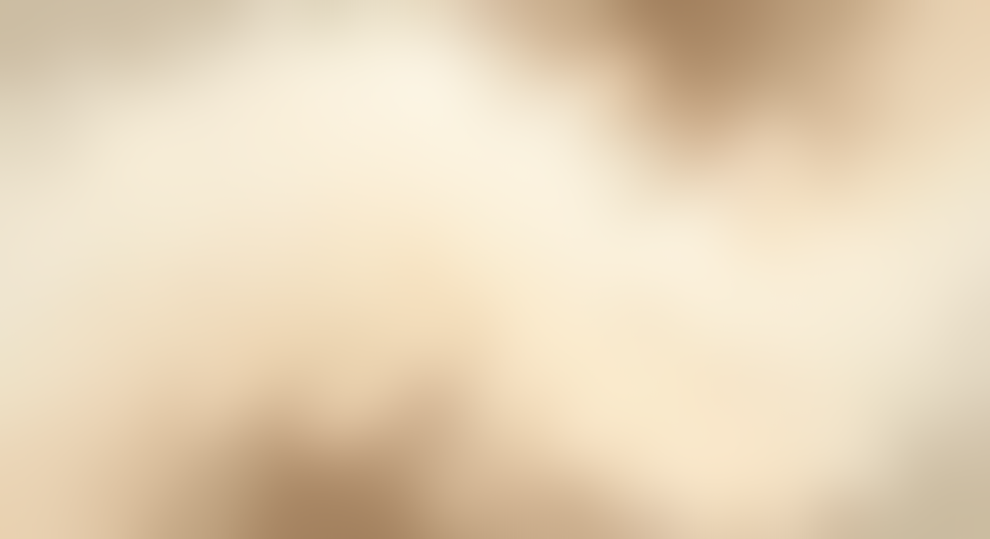 Close-up of a sandy beach with pinkish-brown and beige tones.