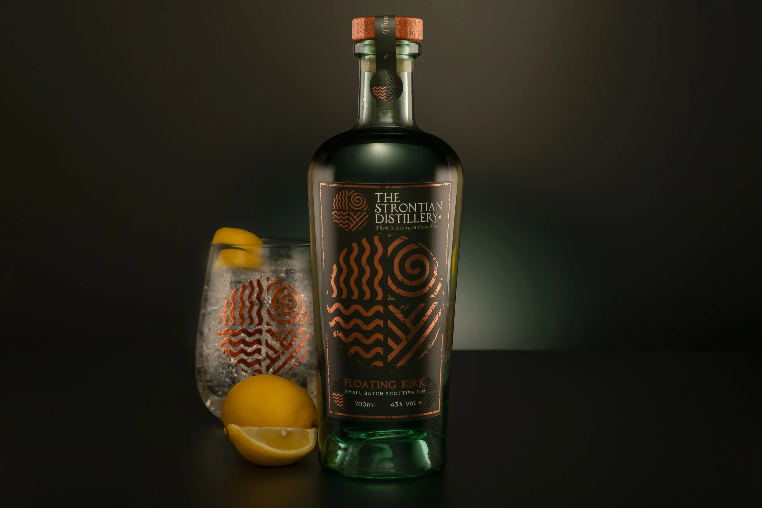Strontian Gin Floating Kirk bottle photograph with Strontian Gin Branded Glass and lemon
