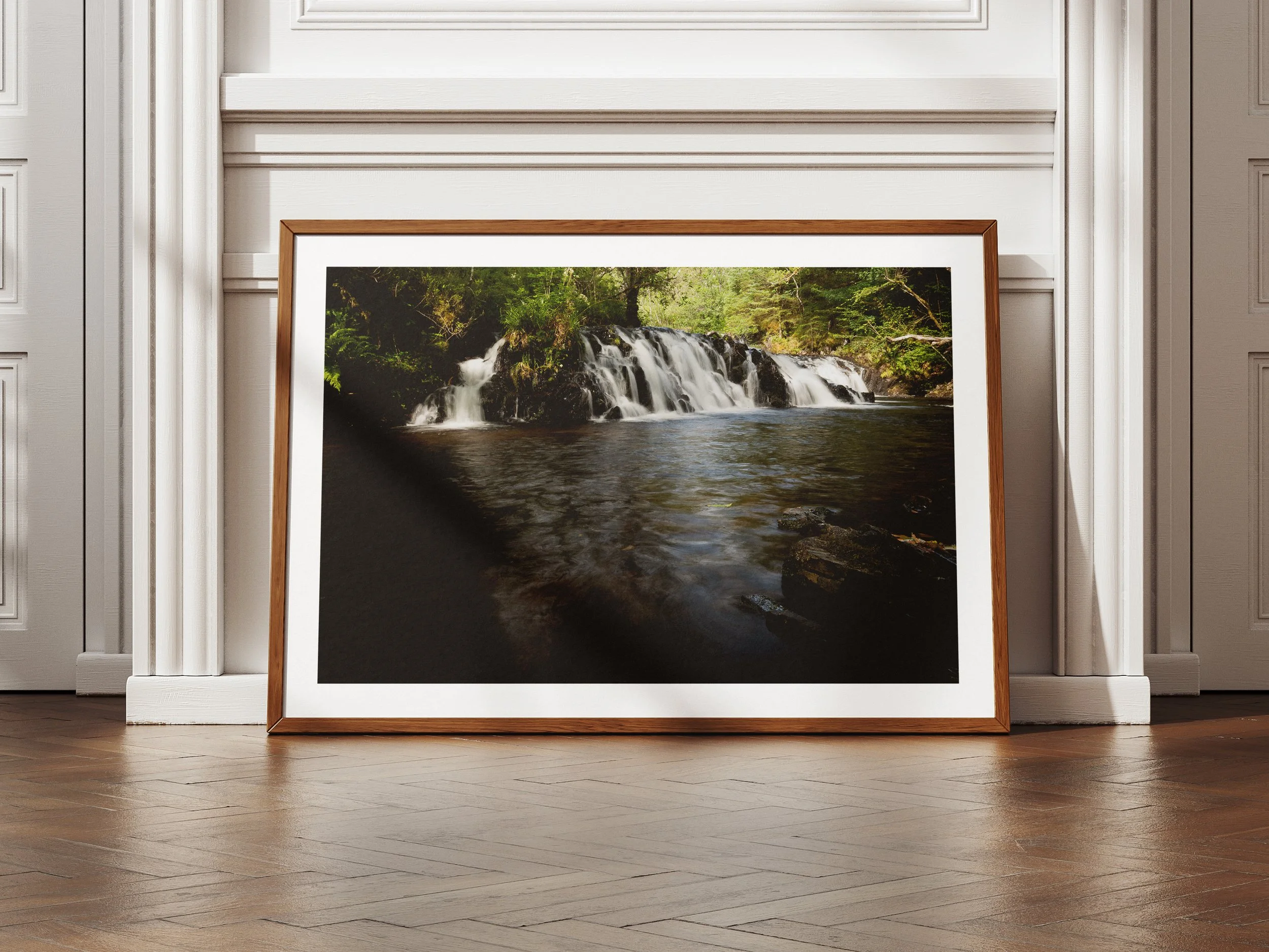 A framed picture of the River Avich Falls