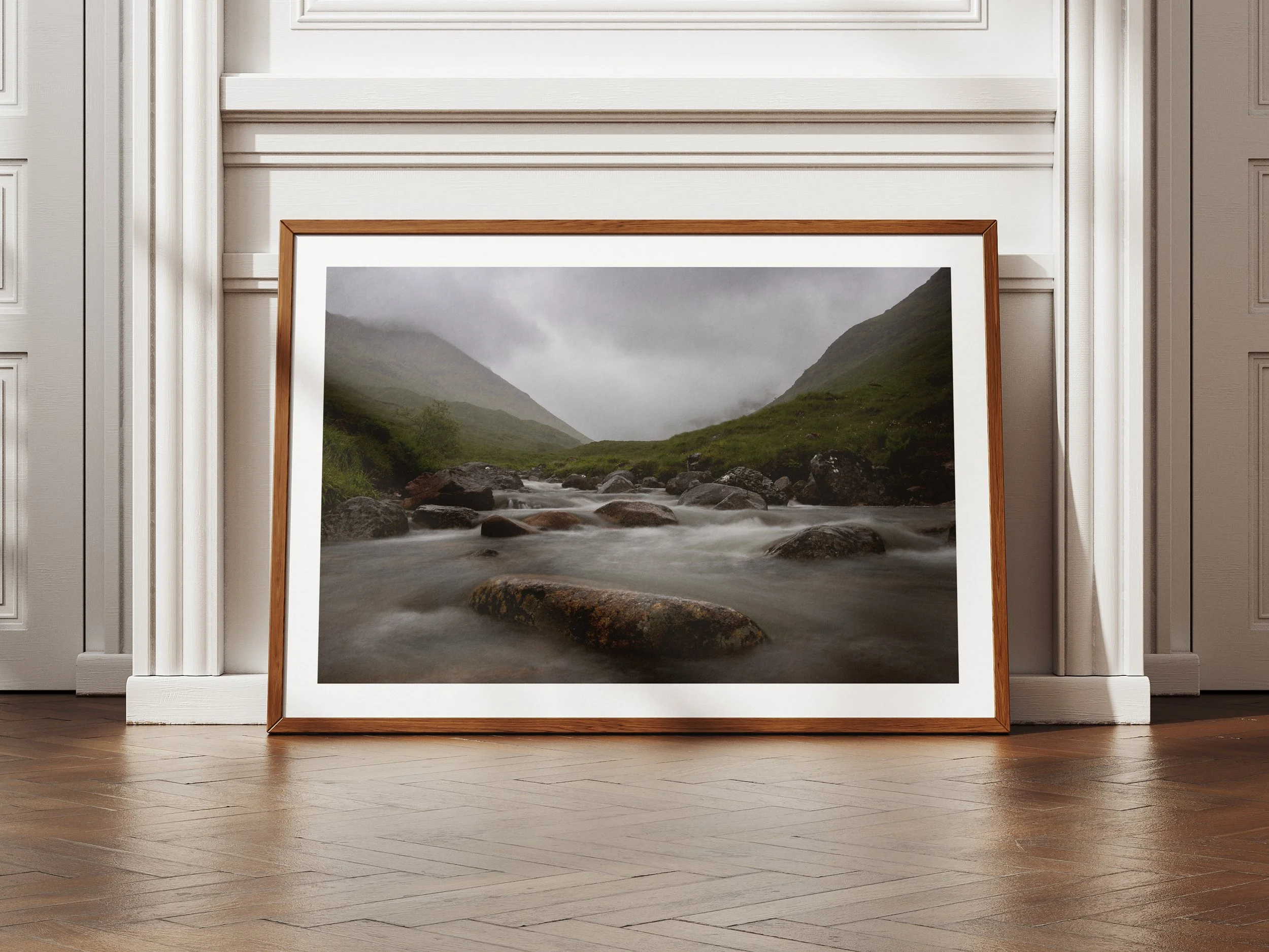 A framed picture of a rock in a river somewhere in Glencoe
