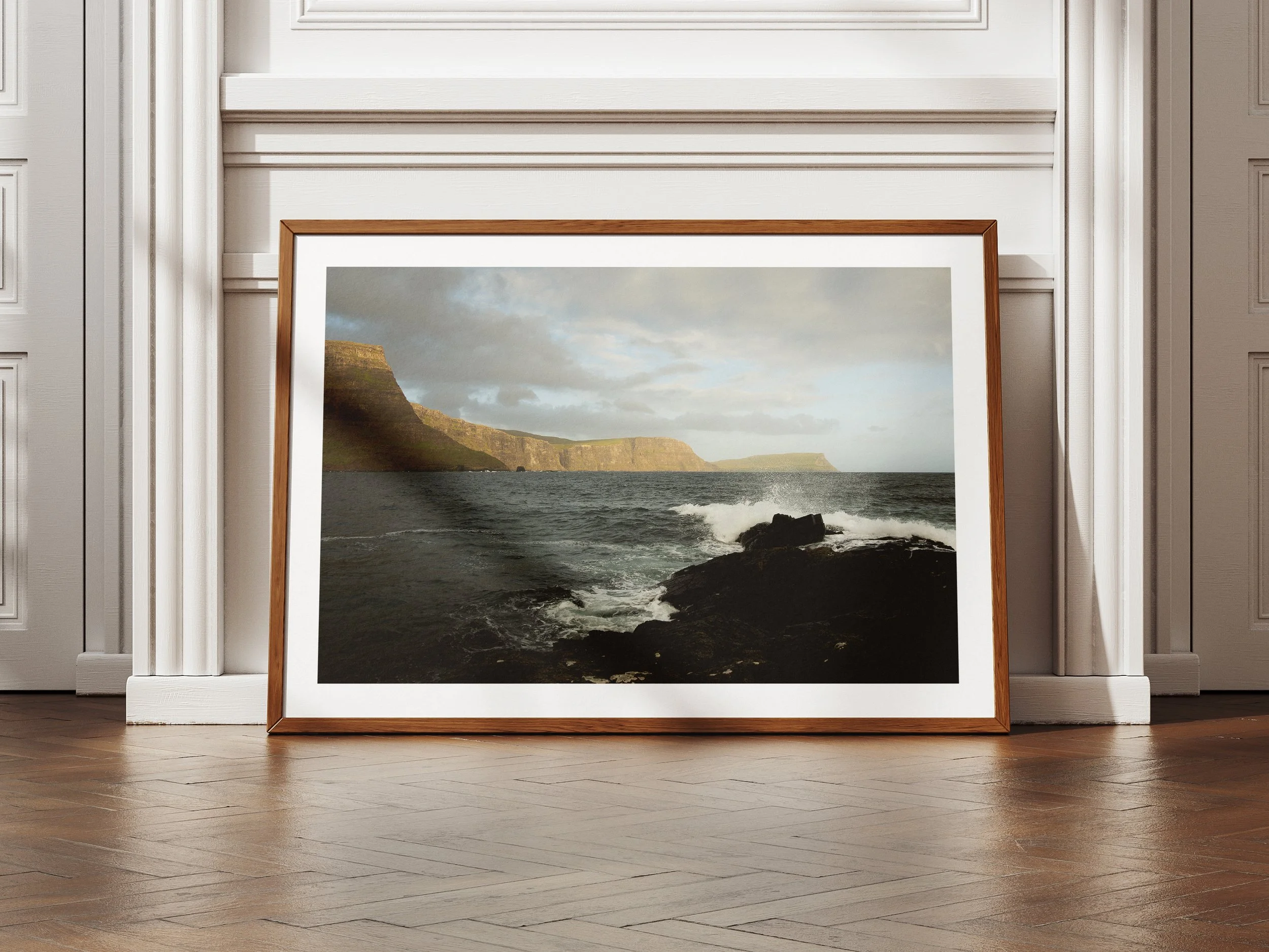 a framed picture of three cliff faces against the rough seas of the Isle of Skye