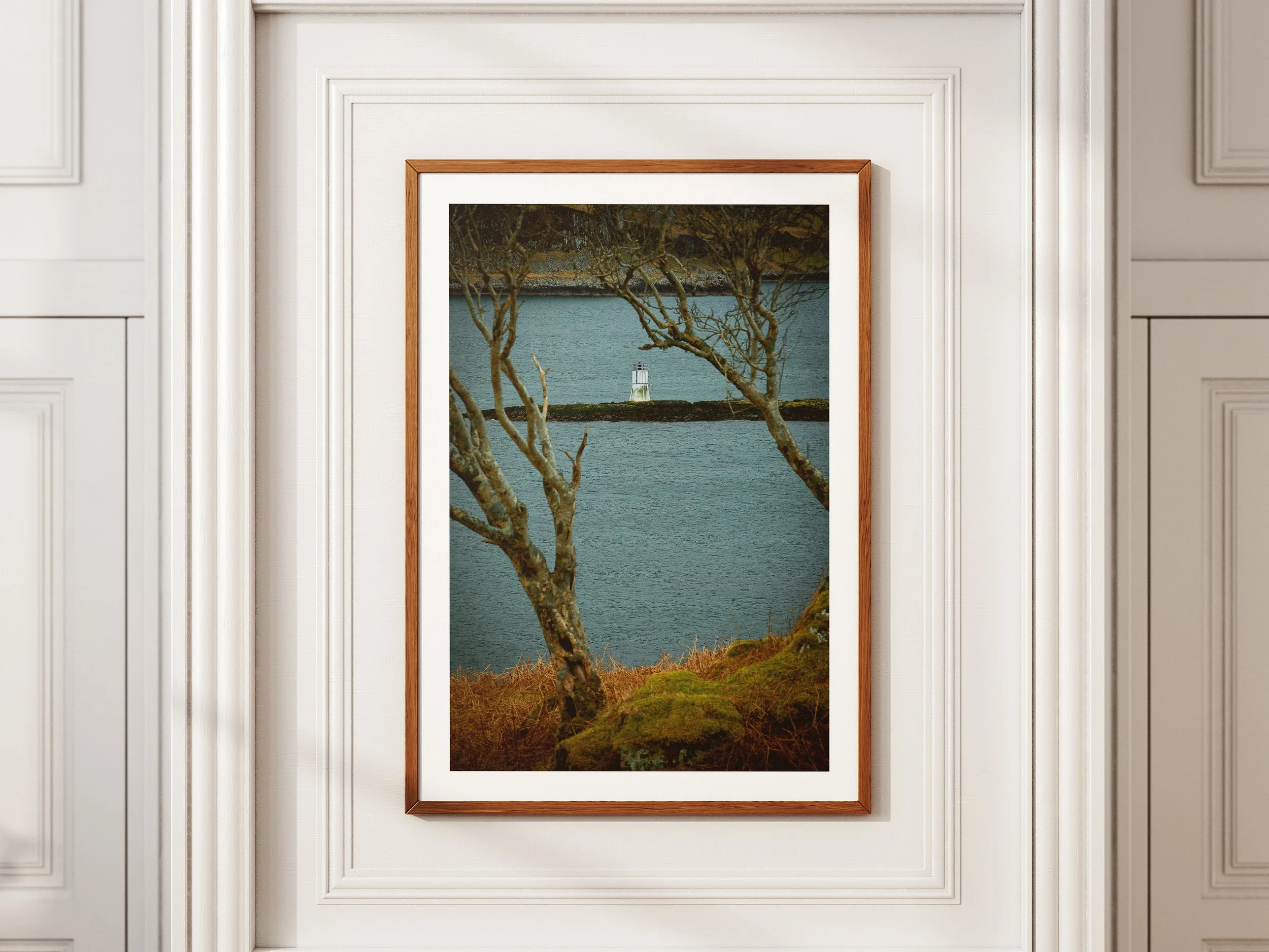 A framed picture of a little white lighthouse