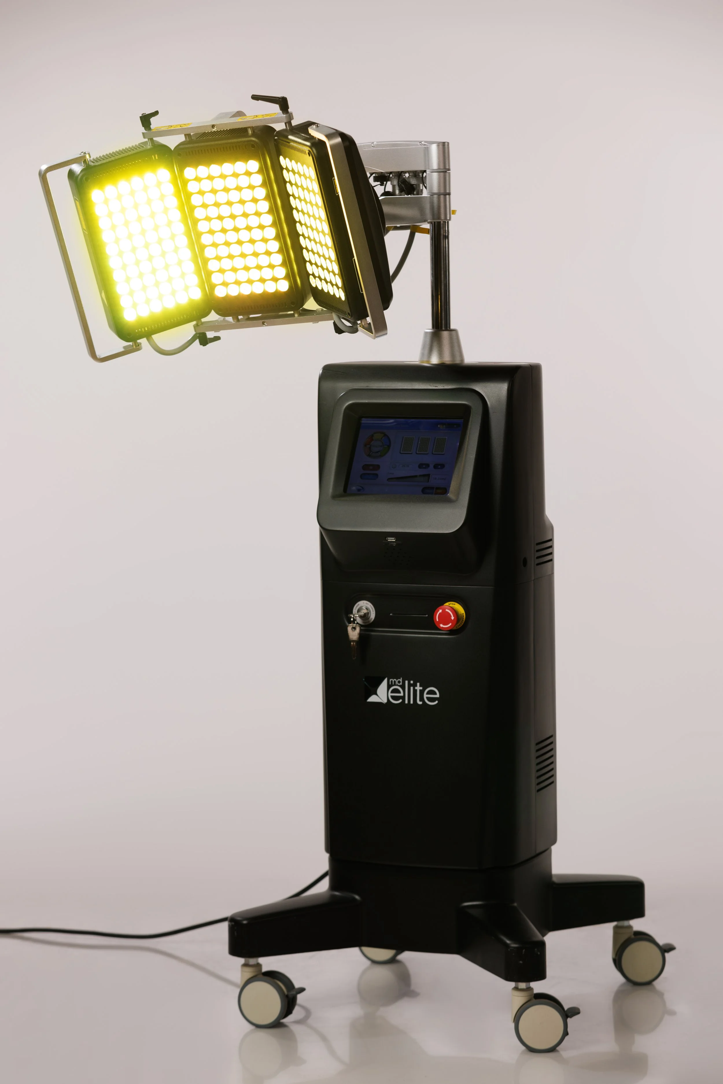 Medical laser device with bright yellow-green light and digital display screen.