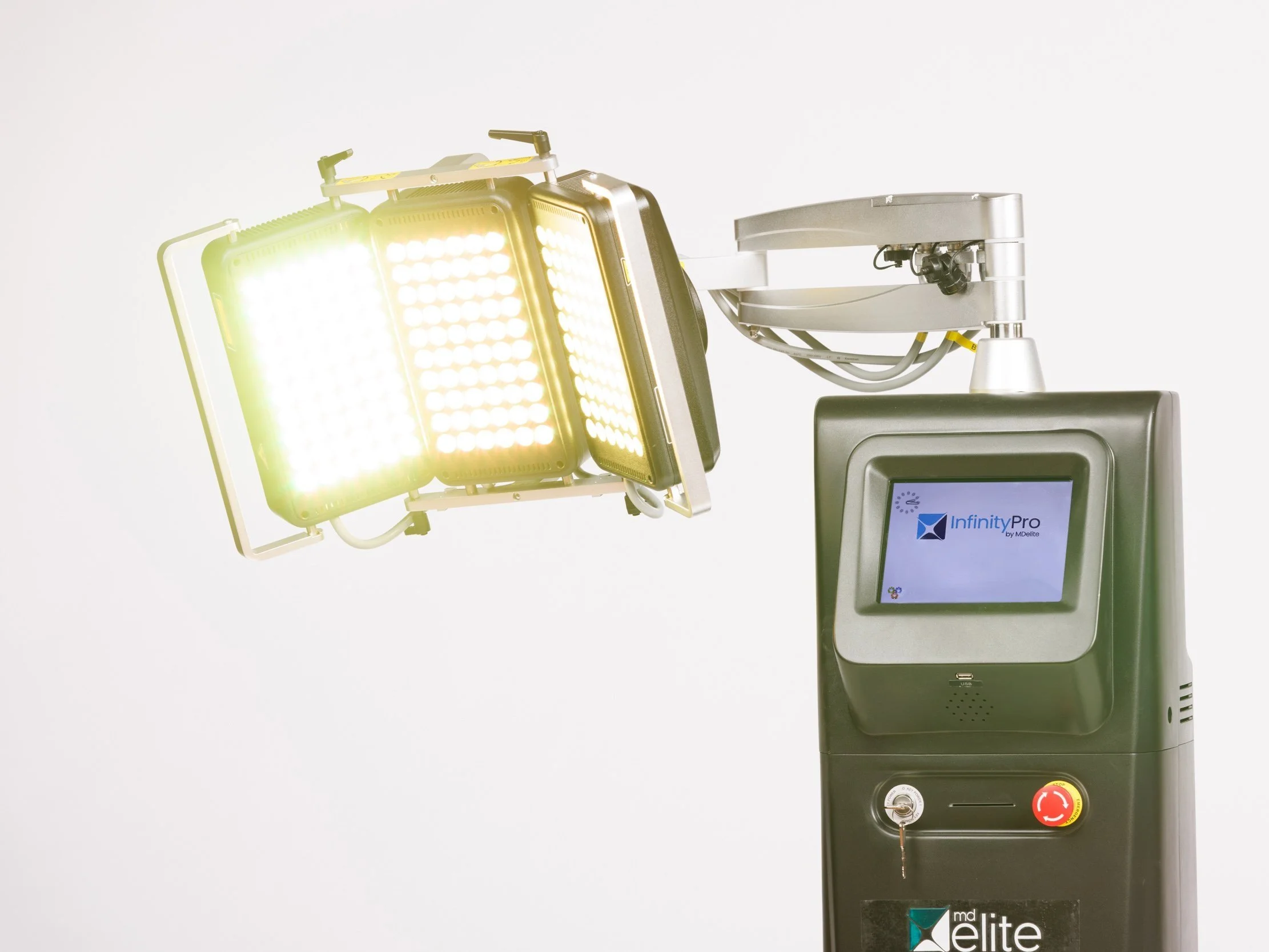 Medical laser device with bright yellow-green light and digital display screen.